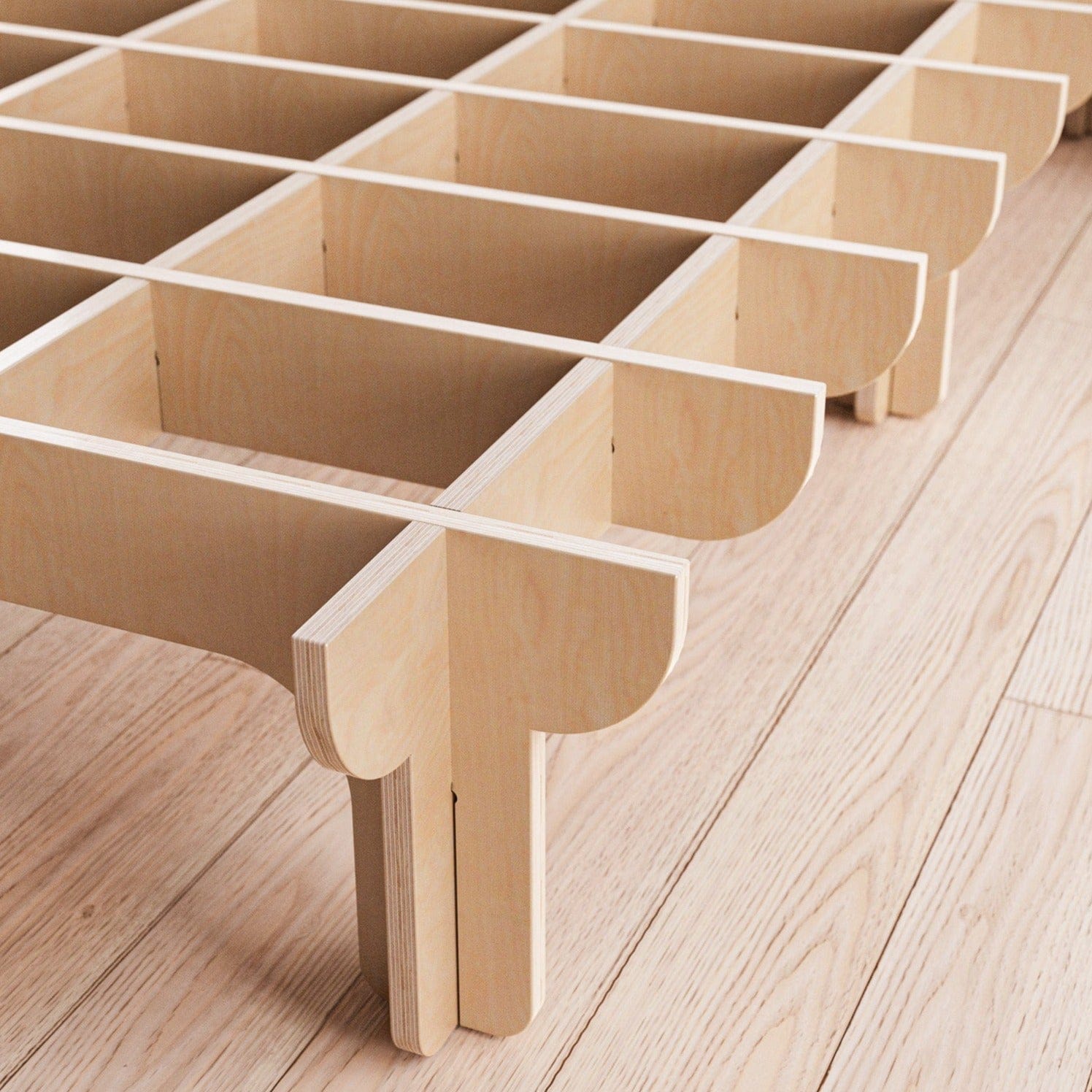 Close-up of the DOVID bed frame’s unfinished natural wood support system, showing interlocking slats, rounded joints and multiple legs