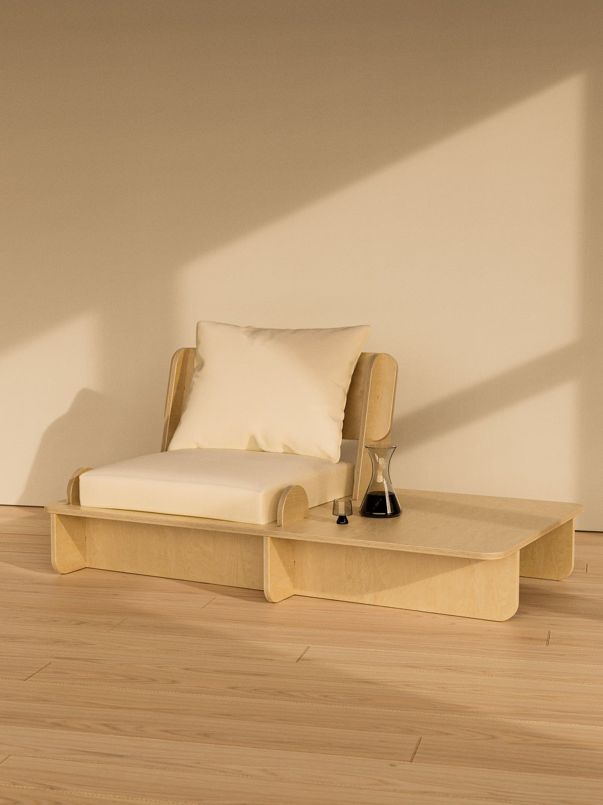 Single-seat Franklin Low Seater with white cushions and a natural wood frame in a warmly lit minimalist room