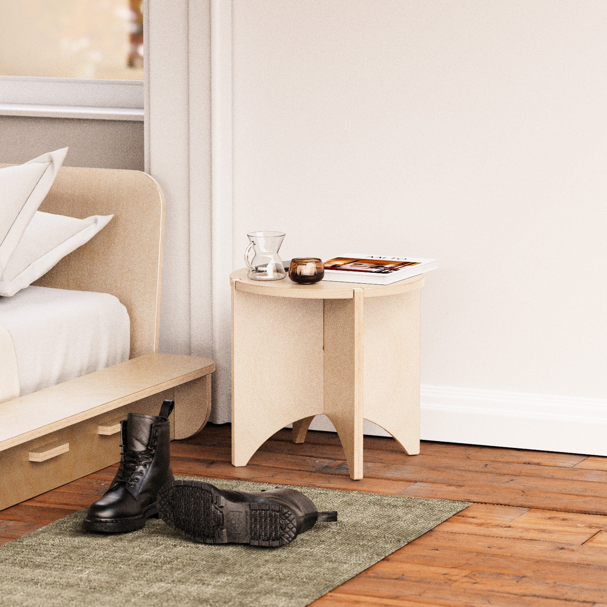 YOYO natural wood end table used as a bedside table, styled with small accessories beside an upholstered bed and black boots