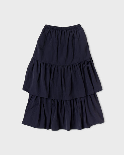 Dark navy Paulette Louise Tier Skirt displayed against a light background, showing a gathered waistband, a gently flared upper section, and two full gathered tiers.