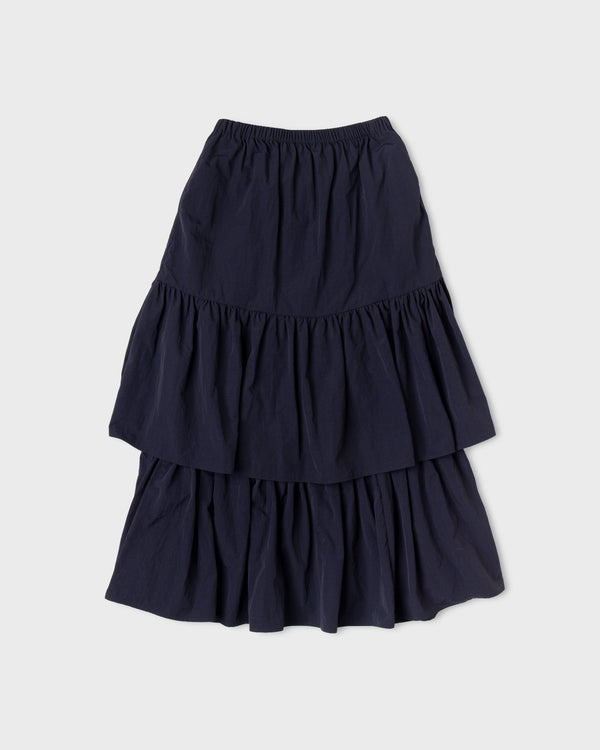 Dark navy Paulette Louise Tier Skirt displayed against a light background, showing a gathered waistband, a gently flared upper section, and two full gathered tiers.