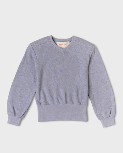 Light gray Paulette Madeleine Top displayed against a light background, showing a shallow V-neck, structured shoulders, loose sleeves gathered into ribbed cuffs, and a broad ribbed hem.