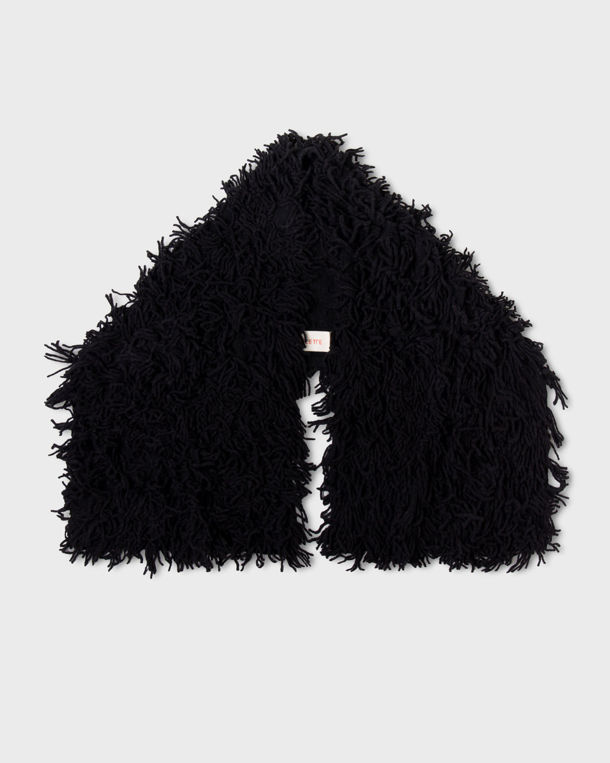 Black Paulette Saint-Jean-de-Luz Oversize Scarf arranged against a light background, showing two broad ends, a central opening, and a thick shaggy texture.