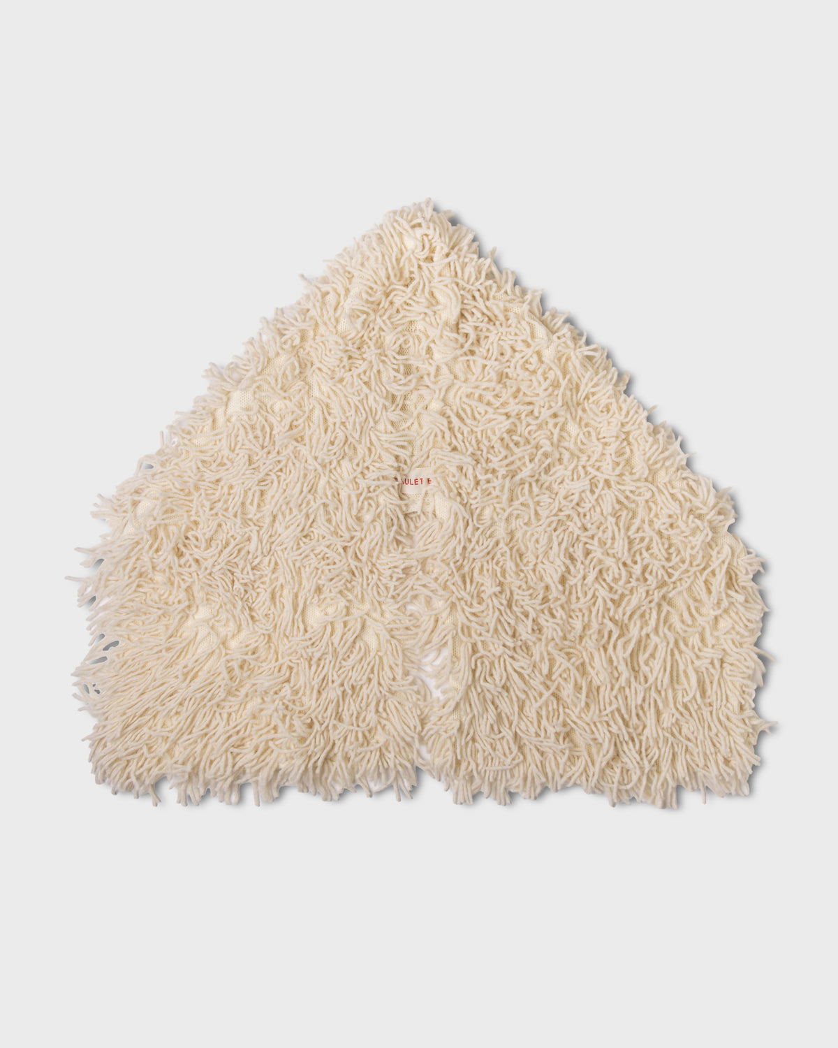 Ivory Paulette Saint-Jean-de-Luz Oversize Scarf arranged against a light background, showing its broad shape, two hanging ends, and dense texture of long, loose strands.