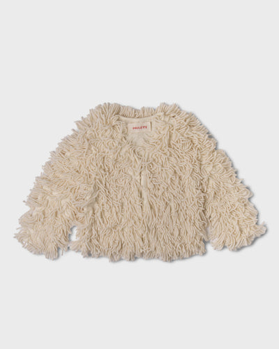 Ivory Paulette Saint-Jean-de-Luz Cardigan displayed against a light gray background, showing a wide, short silhouette, long sleeves, and shaggy strands extending beyond the cuffs and hem.