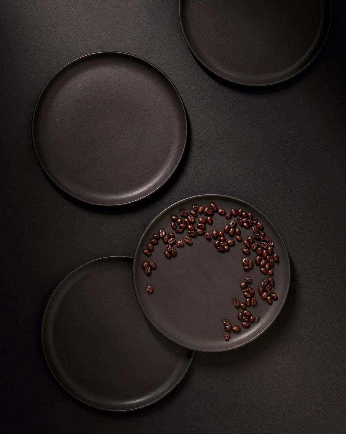 Gharyan Stoneware Japandi Tableware 12pc Dinnerware Set, Matte Black, styled with peppercorns
