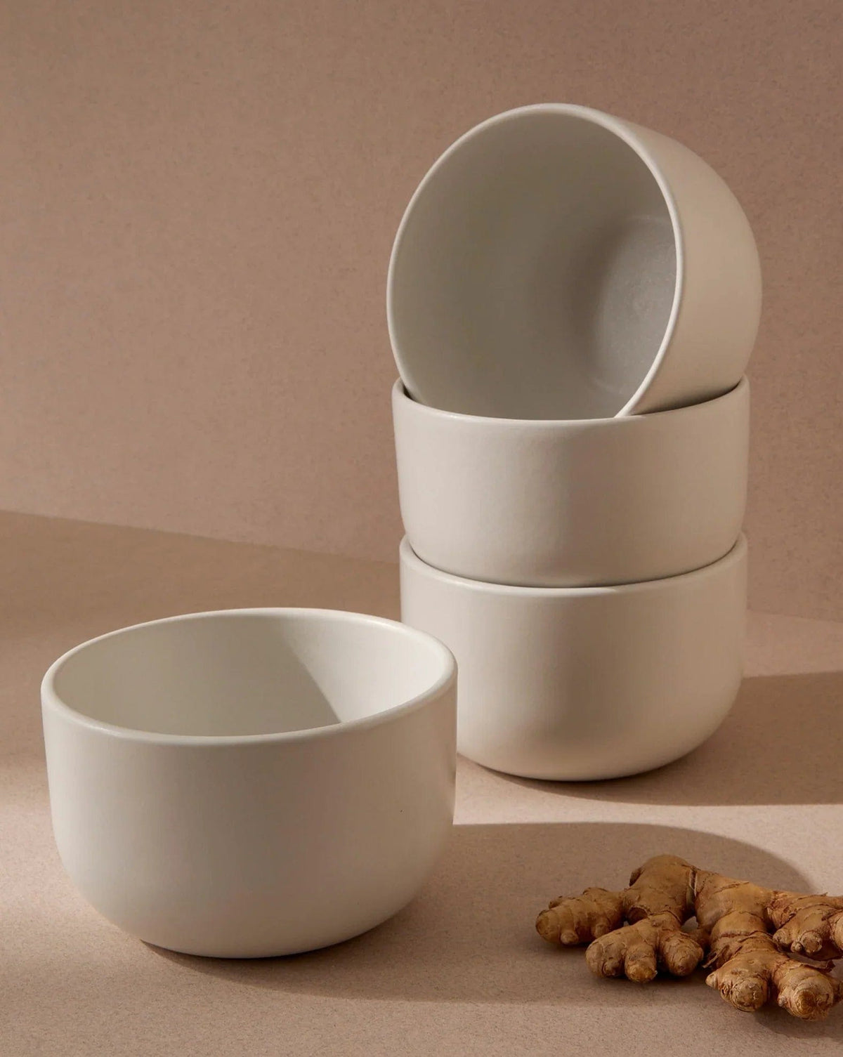Gharyan Stoneware Japandi Tableware 12pc Dinnerware Set, Matte White, bowls stacked with ginger