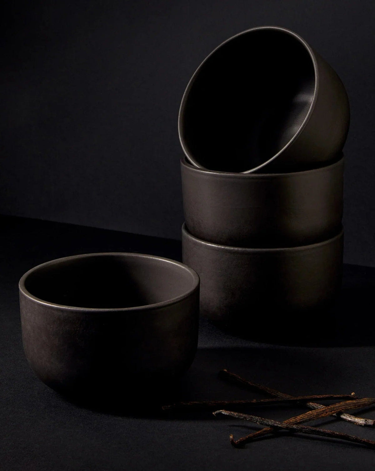 Gharyan Stoneware Japandi Tableware 12pc Dinnerware Set, Matte Black, bowls stacked with utensils