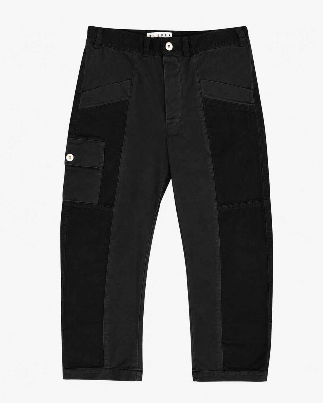 Front product view of black Trek pants with tonal utility panels and a buttoned cargo pocket.