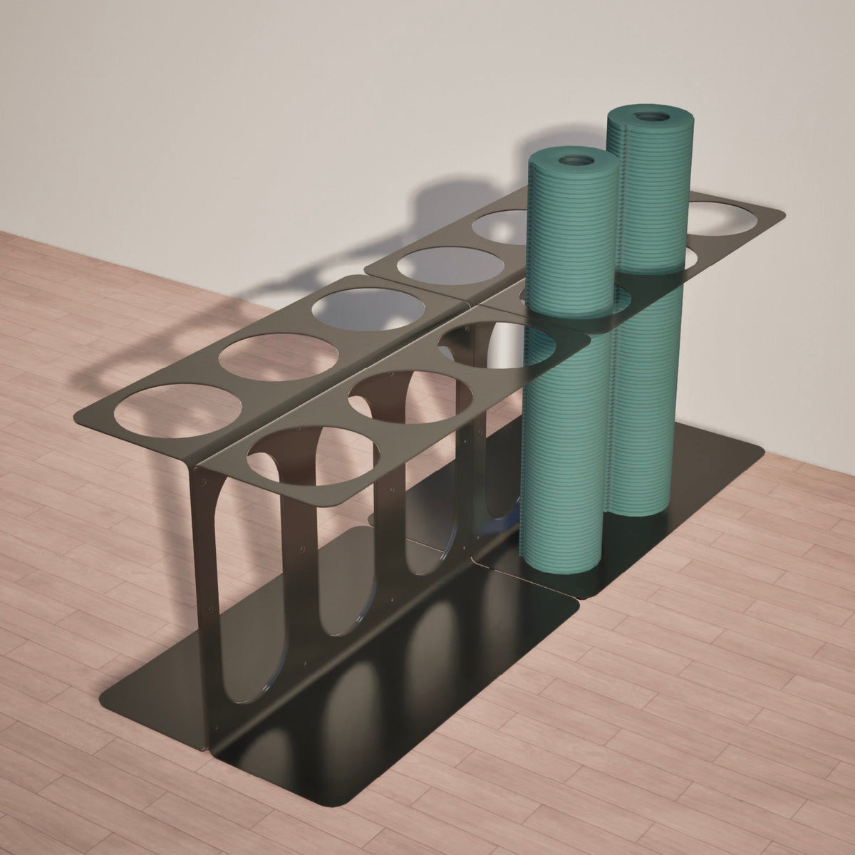 Black metal floor stand holding two teal foam rollers, with four remaining circular storage slots left open.
