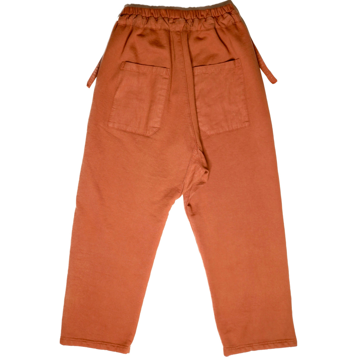 Back product view of rust-orange Picasso pants with an elastic waistband and two patch pockets.