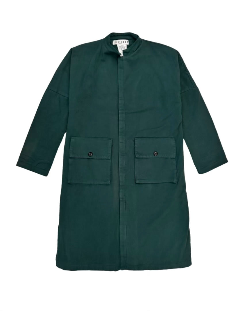 Front product view of the deep teal-green Passage Jacket with a band collar and flap pockets.
