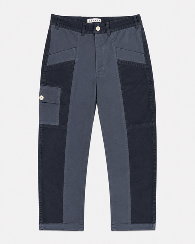 Front product view of slate-blue Trek pants with contrasting tonal panels and a buttoned cargo pocket.