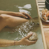 Sugi Japanese Bath Flakes in bath tub in the water