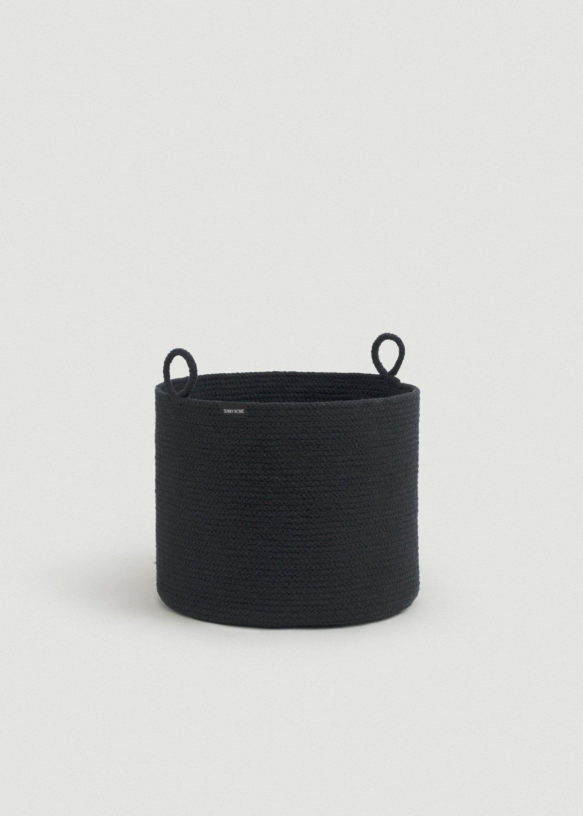 Short black rope basket with tightly coiled sides and matching loop handles.