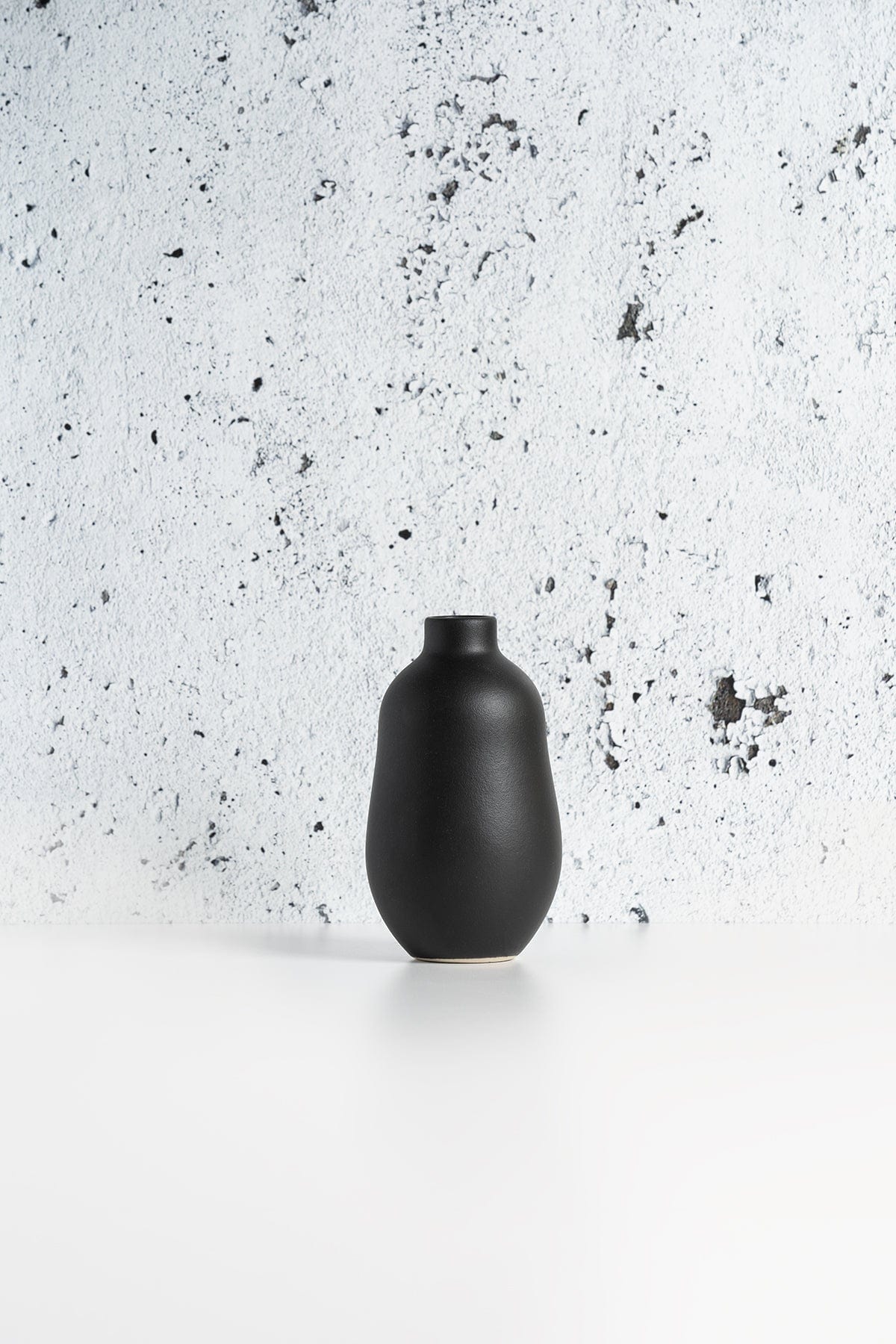 Gharyan Stoneware Vase, black, against speckled textured background