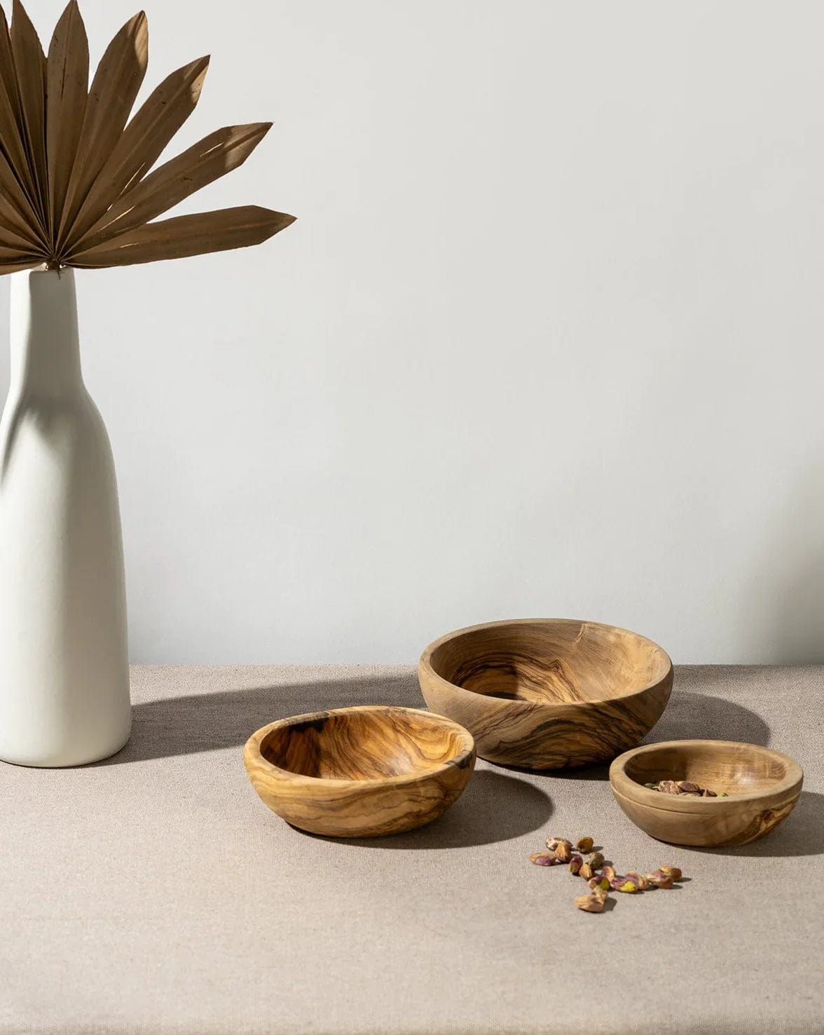 Gharyan Stoneware Olive Wood Nesting Bowls, set of 3, styled with vase and dried florals