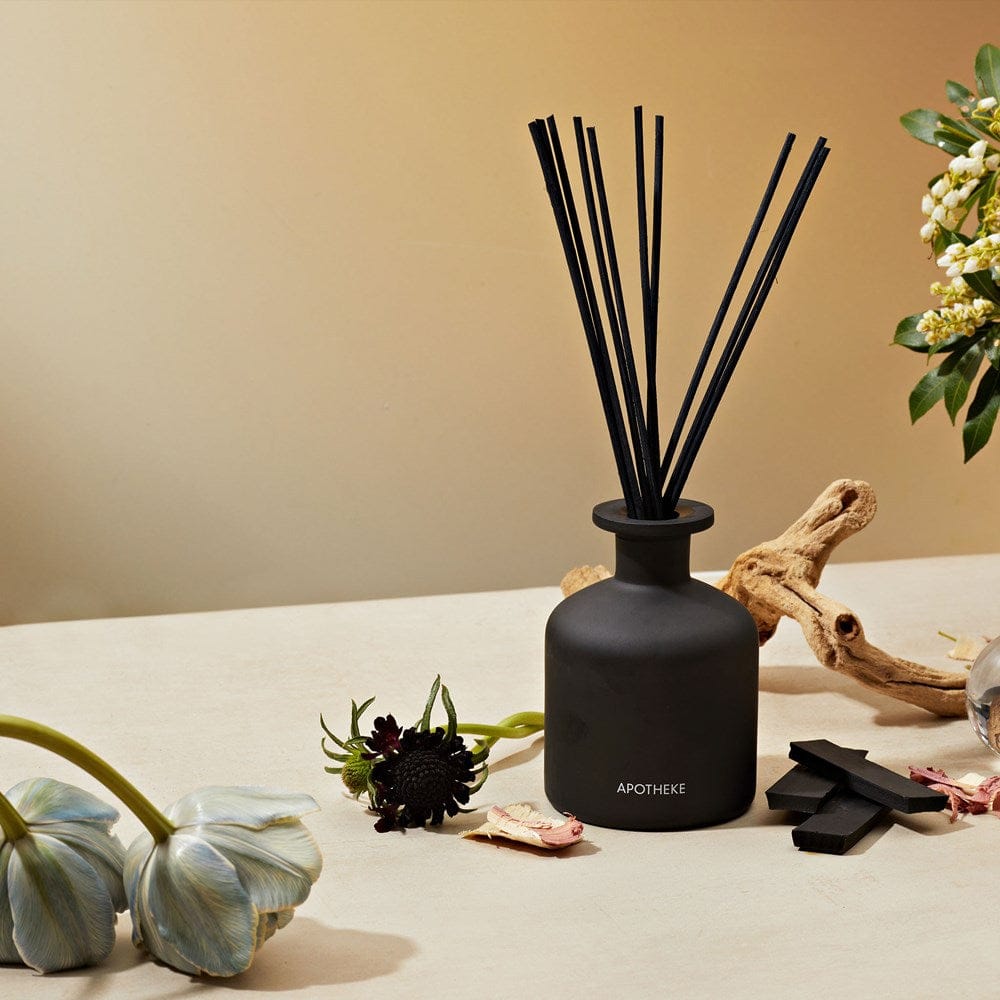 APOTHEKE Charcoal Reed Diffuser styled on a table with dried florals and driftwood