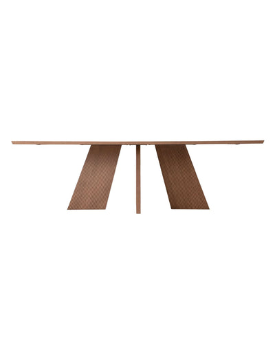 Close-up of HAKAMA Table sculpted legs – wave-grooved walnut detail