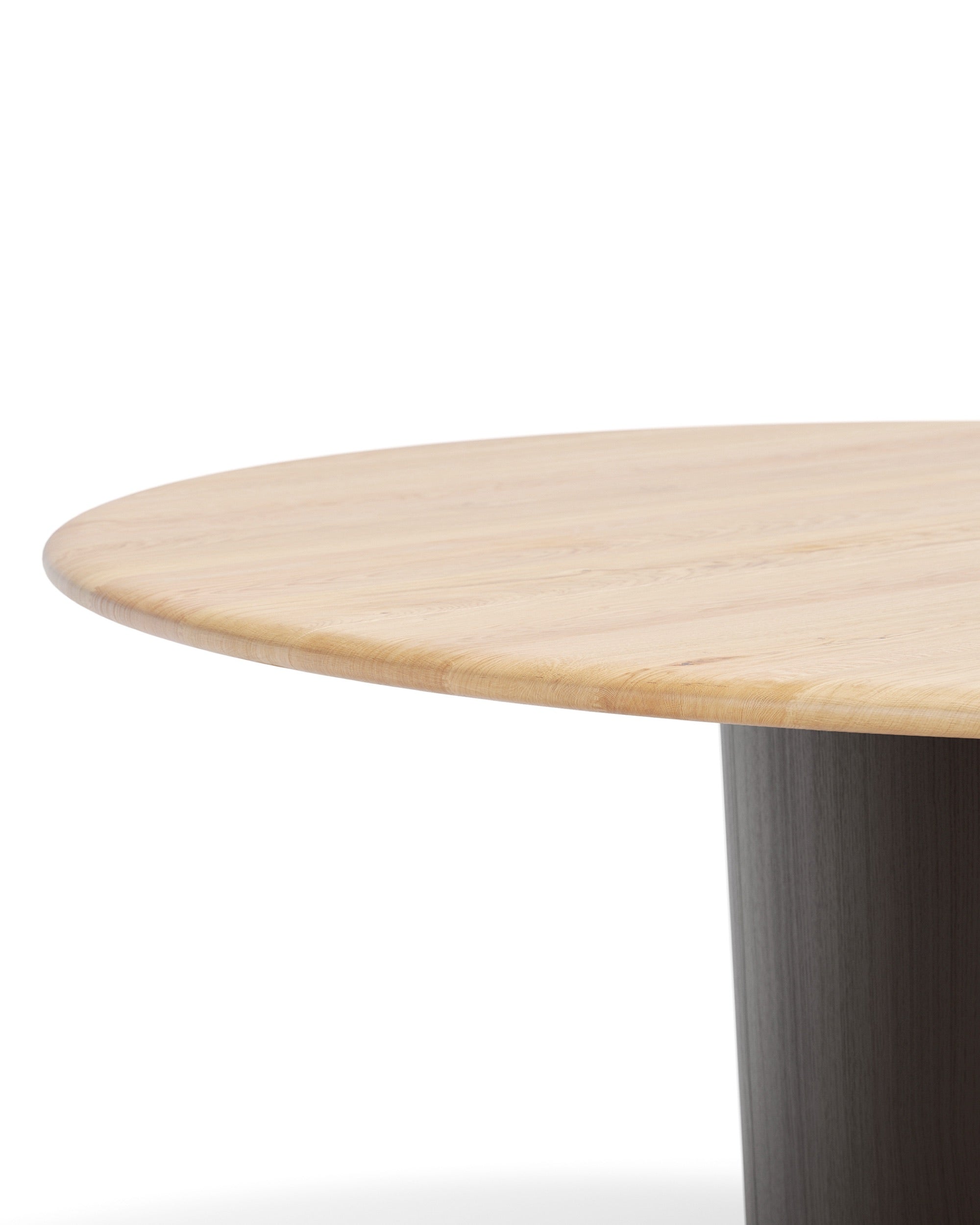Close-up of oak tabletop edge with dark pedestal base ONE Round Table by CondeHouse
