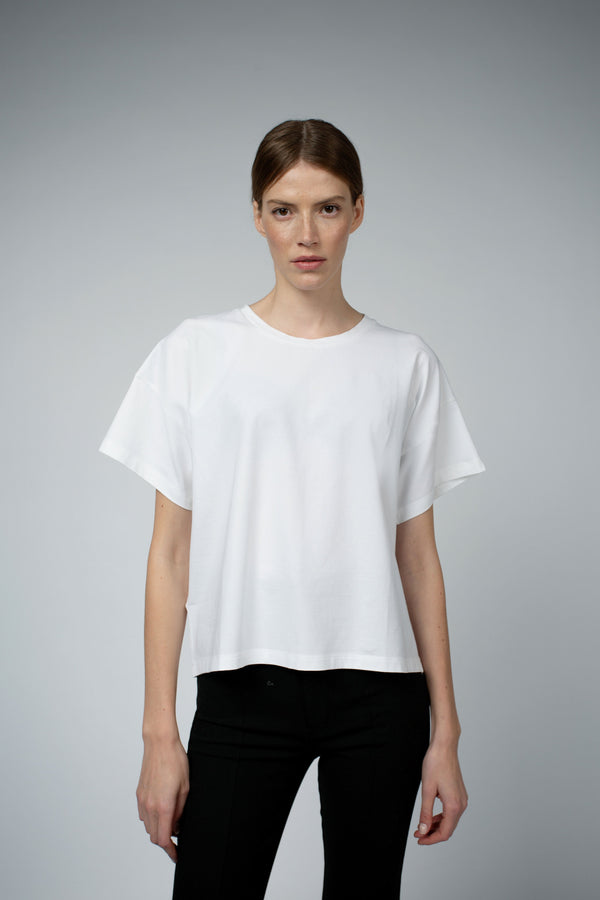 Santicler Bevin Organic Cotton Boyfriend T-Shirt in White – model wearing relaxed boyfriend-fit tee with black trousers, full front view, Japandi capsule wardrobe essential