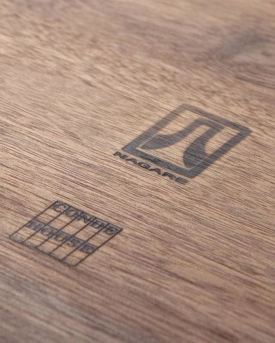 Close-up of walnut grain and craftsmanship on NAGARE Armchair