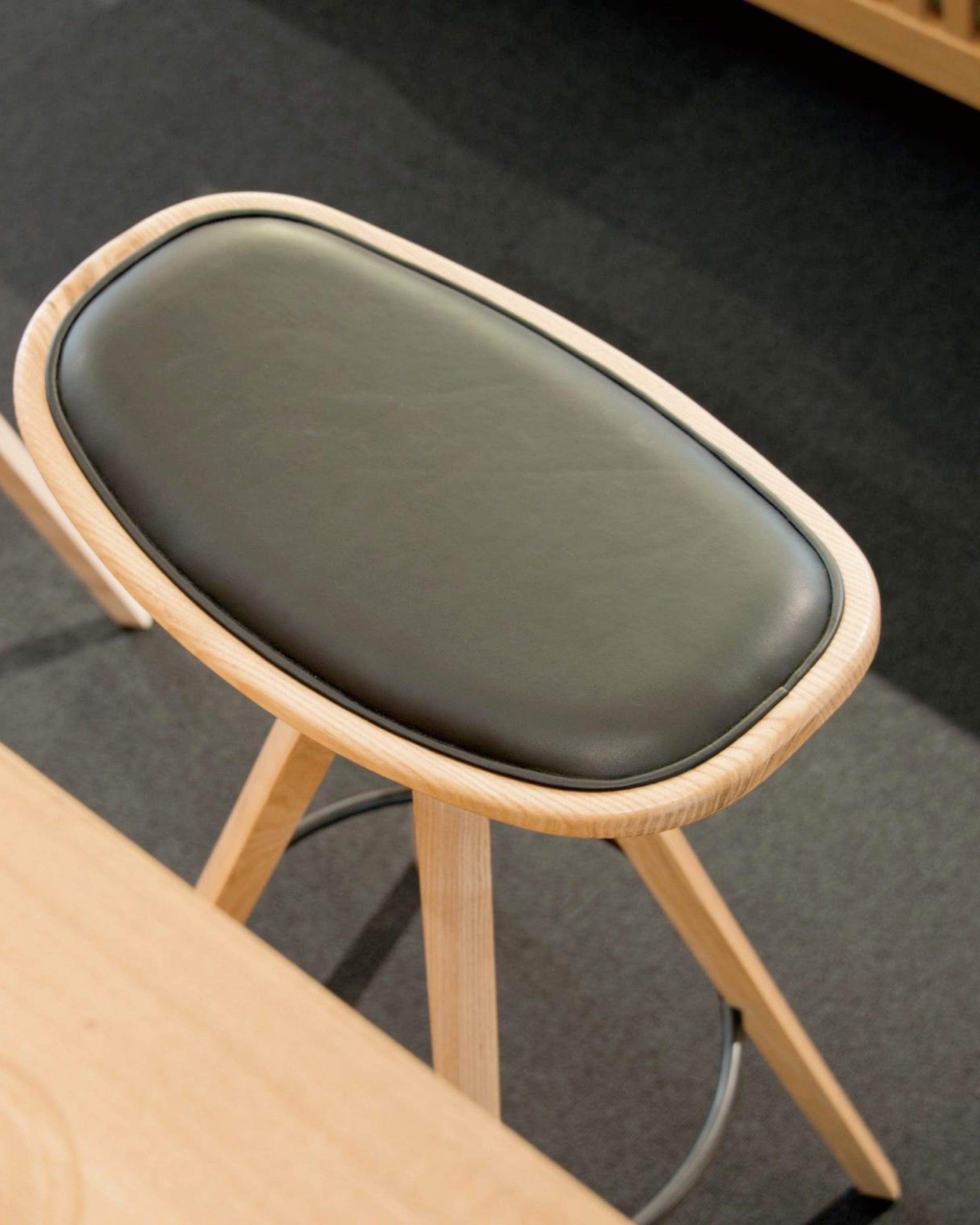Detail of BCTD Bar Stool seat cushion and wood grain on Japanese ash.