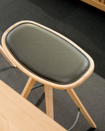 Detail of BCTD Bar Stool seat cushion and wood grain on Japanese ash.