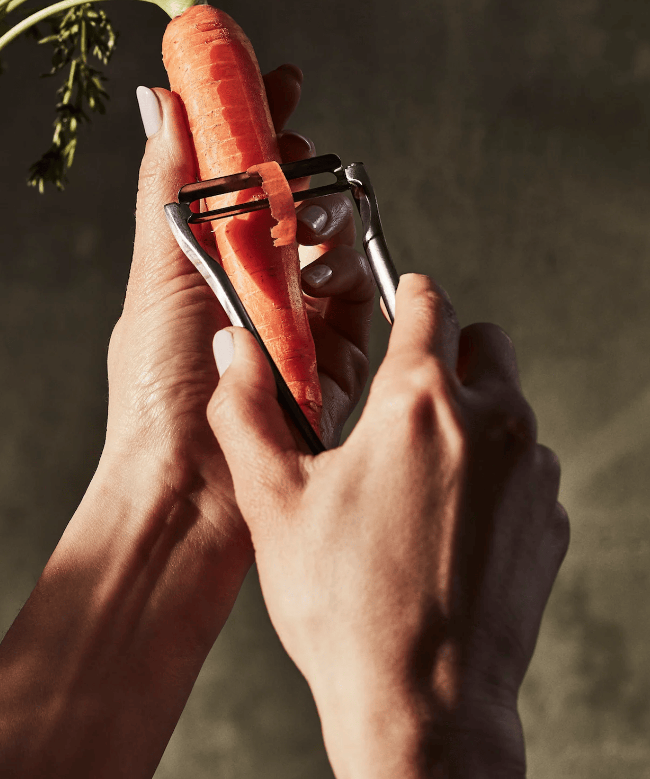 The Forever Peeler in Stainless Steel with carrots