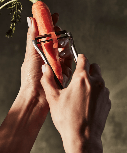 The Forever Peeler in Stainless Steel with carrots
