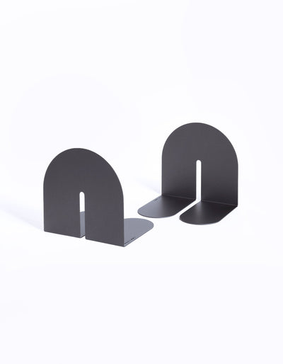 Charcoal Tortuga Forma Dumbo Bookend Pairs - The Architect Collection on white, with one facing forward and the other turned to show its rounded horizontal feet and folded construction.