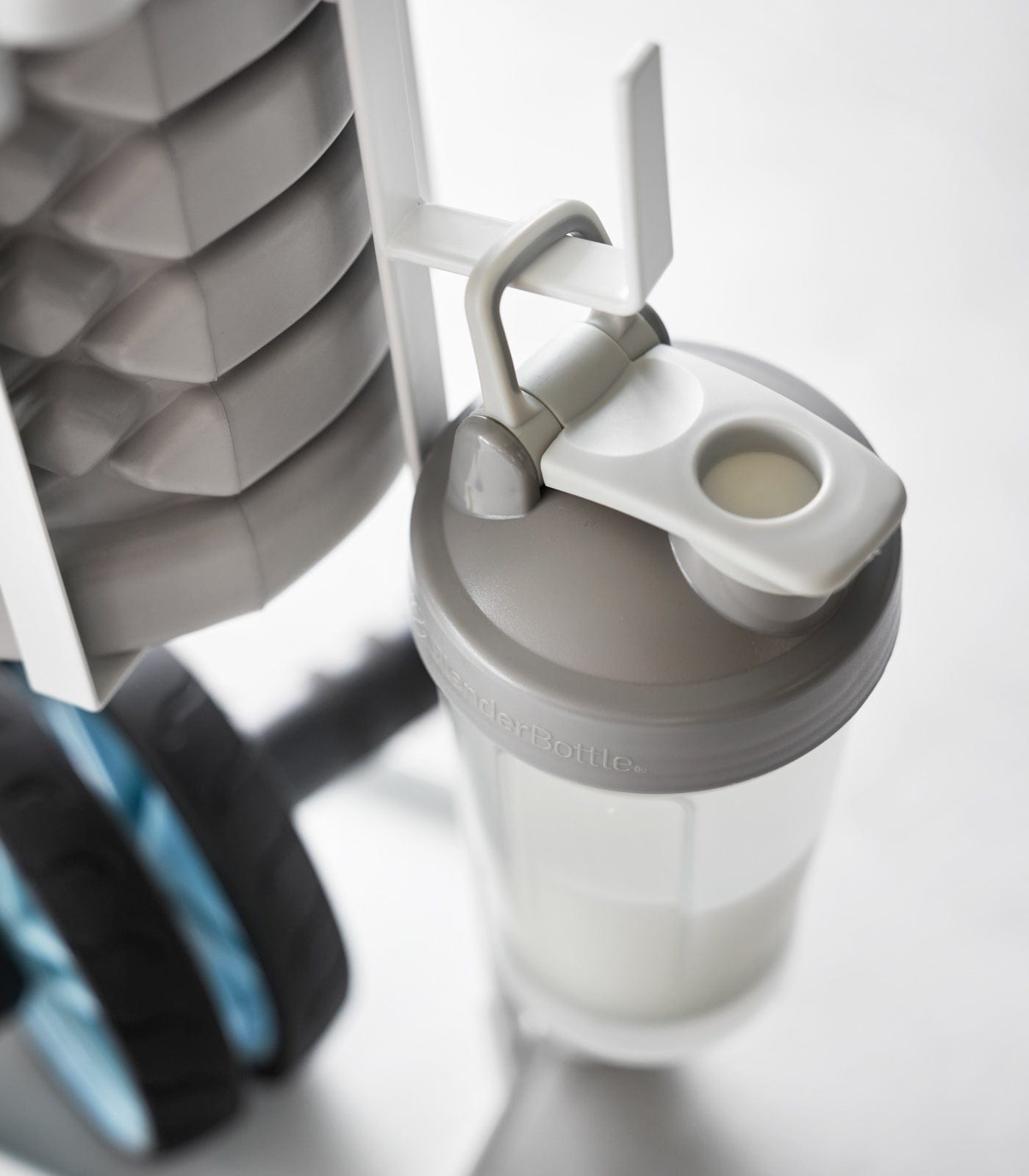 Gray shaker bottle with a white background hanging on a hook