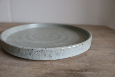 Gray speckled handmade small earthenware plate side profile