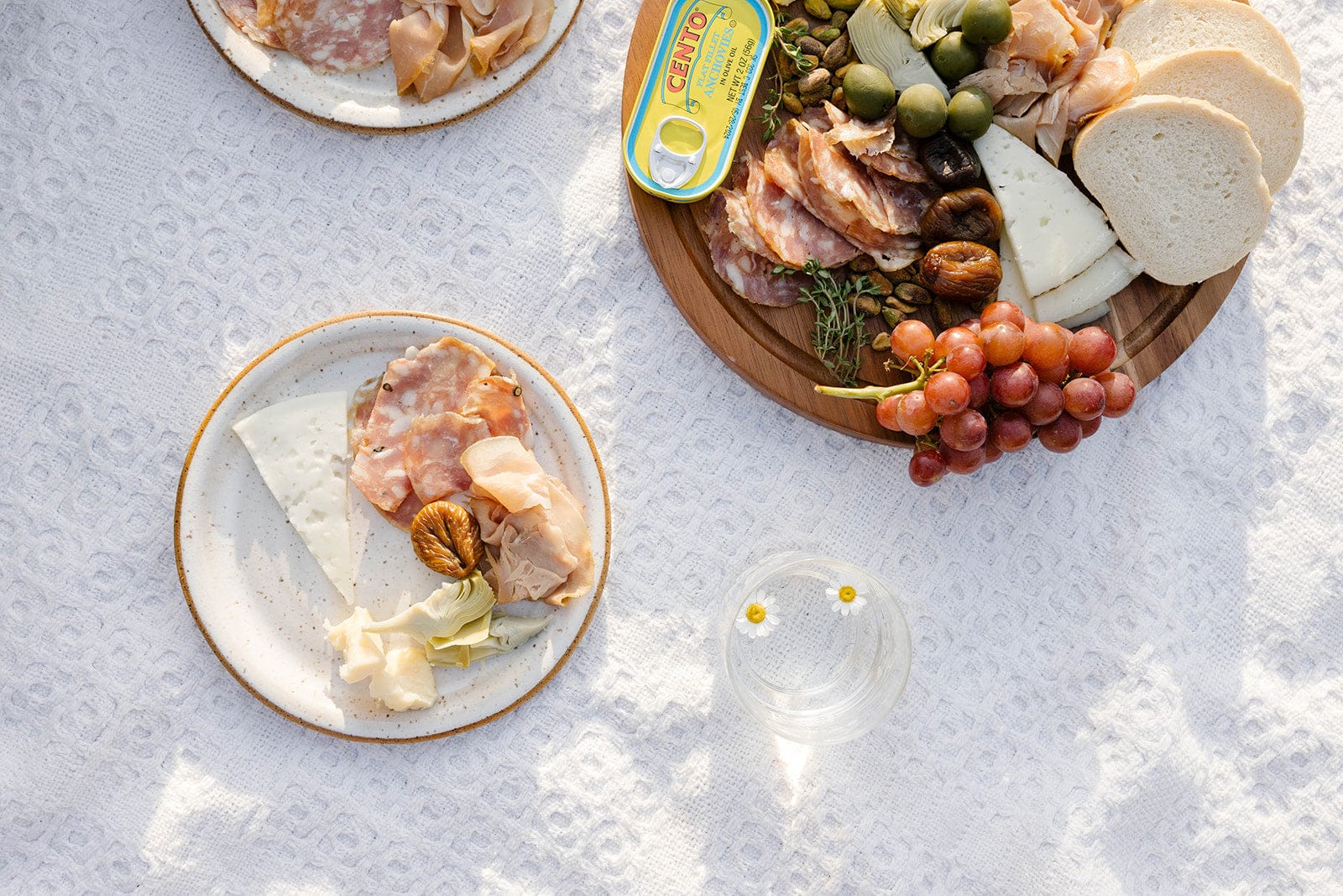 Handmade earthenware dinner plates styled with charcuterie and food