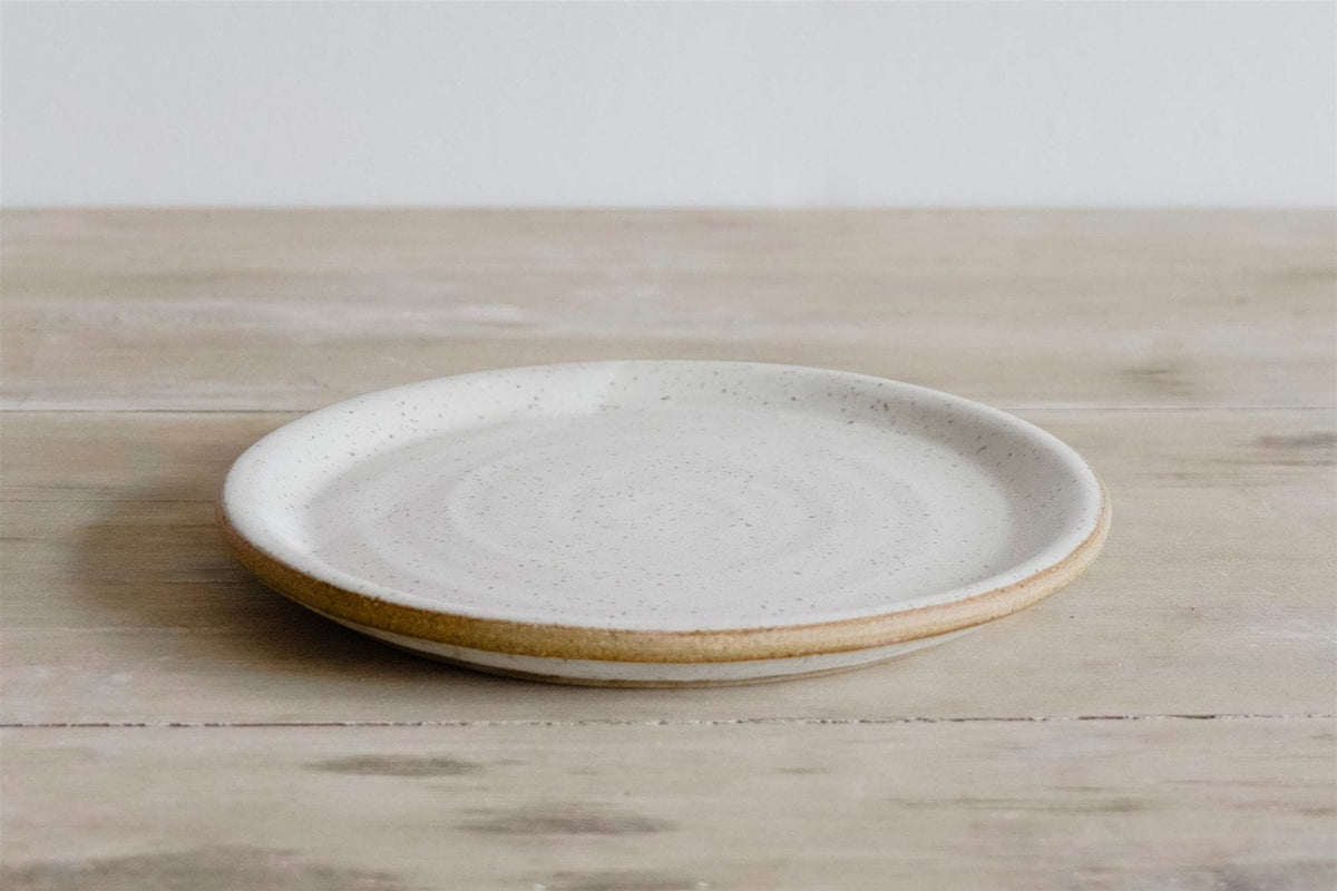 Handmade flat rim earthenware plate in natural glaze