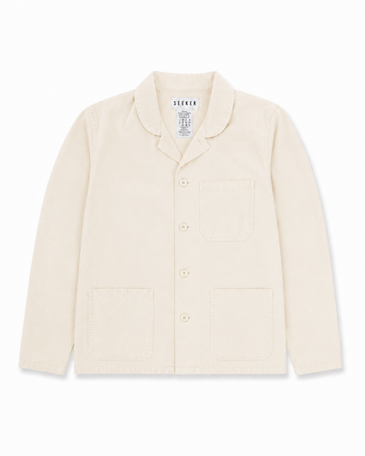 Front product view of the cream Travelers Jacket with a button front, chest pocket, and two lower patch pockets.