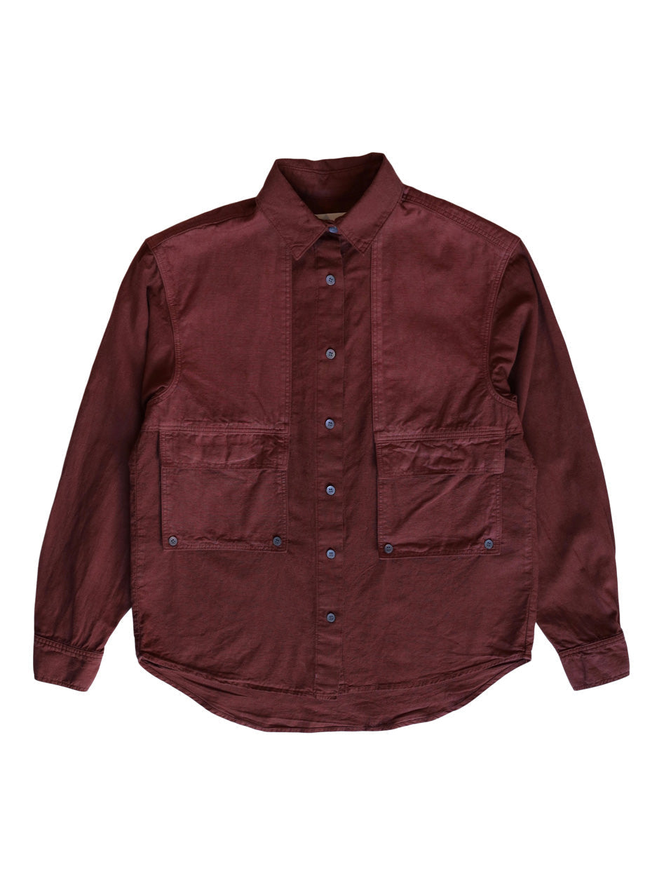 Front product view of the rust-red Trek Shirt with four utility pockets.
