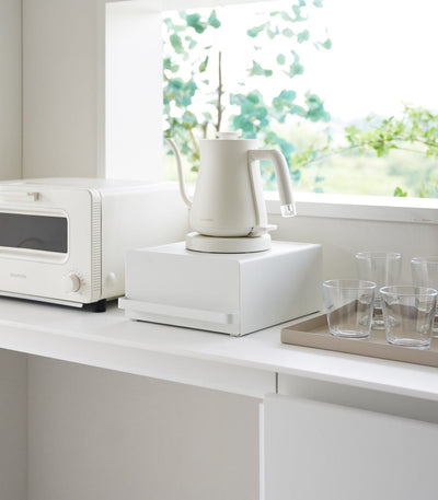 Japandi countertop rack with drawer holding kettle and kitchen essentials