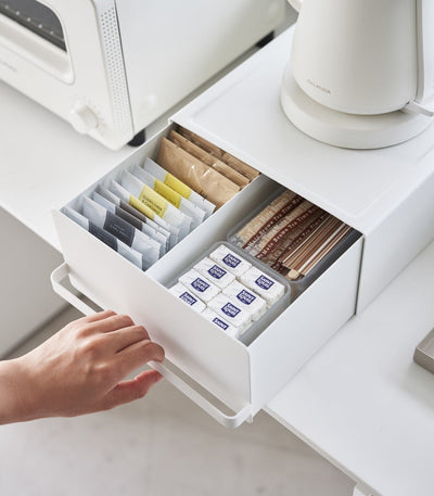 Kitchen organizer drawer storing tea bags sugar and accessories