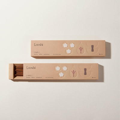 Open and closed tan boxes of Looshi Clarify incense sticks displayed on a cream background