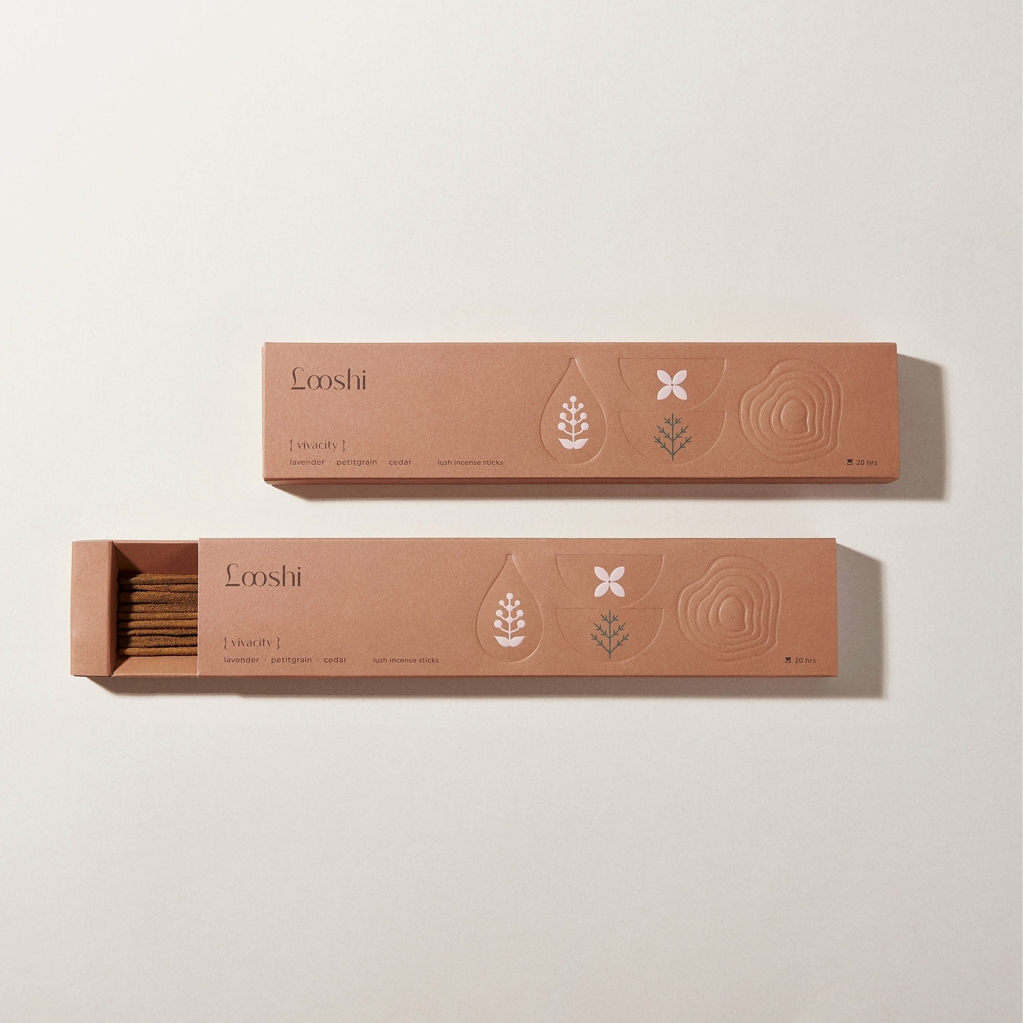 Open and closed warm brown boxes of Looshi Vivacity incense sticks displayed on a cream background