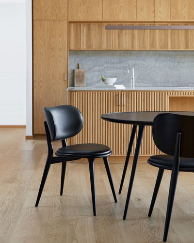 Mater Accent Dining Table paired with dining chairs in contemporary interior