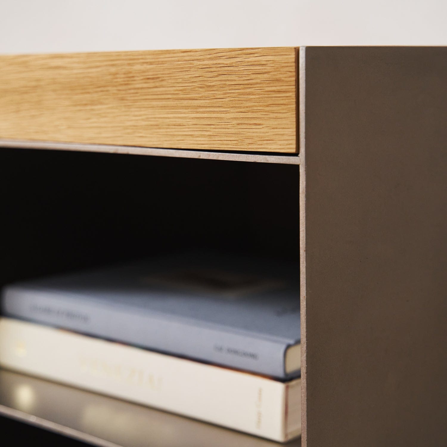 Close-up of Milan media console open shelf with book storage