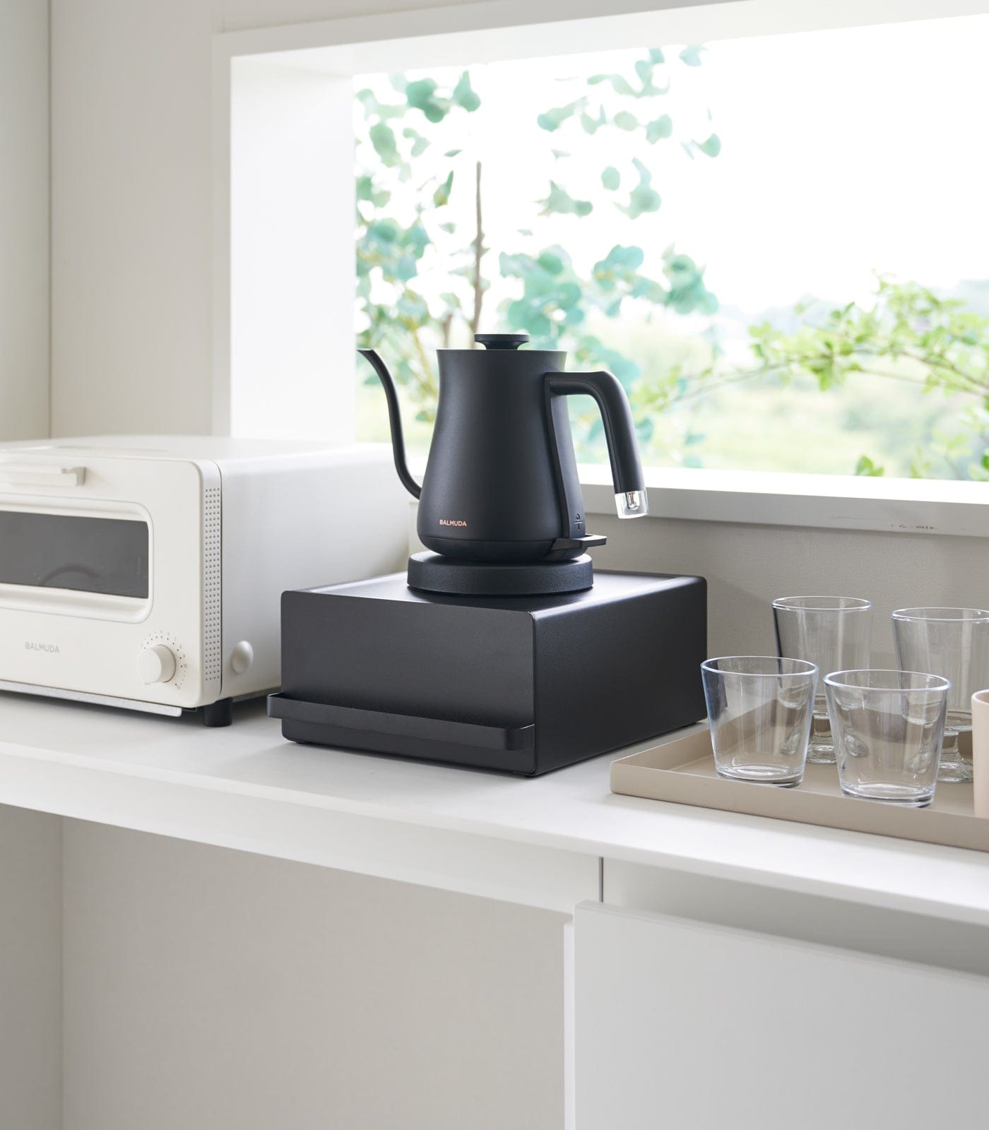 Modern kitchen organizer with drawer and appliance stand in black steel