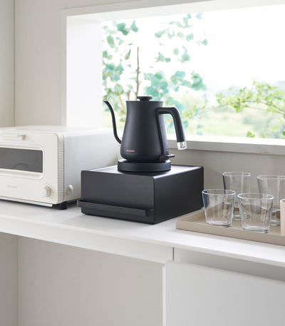 Modern kitchen organizer with drawer and appliance stand in black steel
