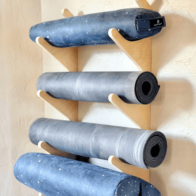 Modern yoga mat wall organizer in neutral studio space