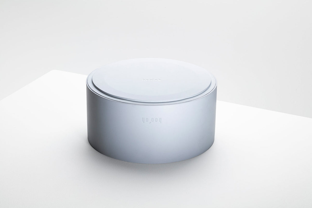 Two pale blue-gray Mogo Bowls nested together, showing their compact stackable cylindrical design.