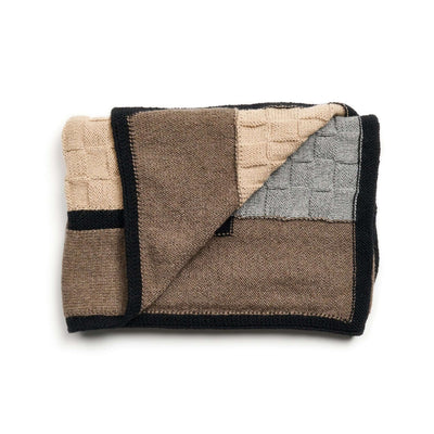 Folded blanket showing the gray basket-knit panel, beige section, and brown reverse.