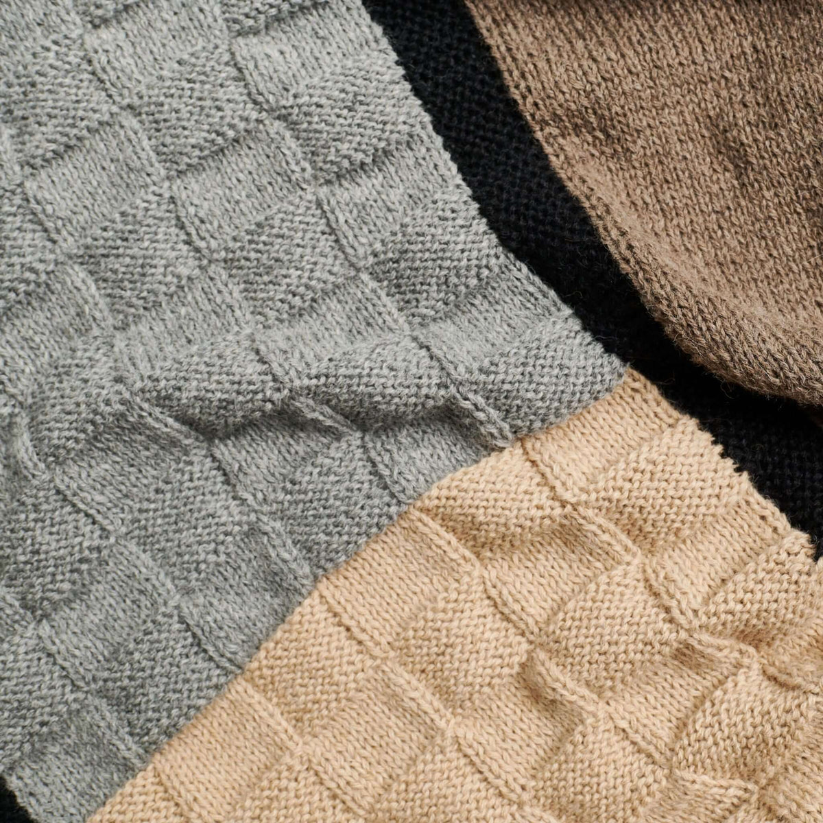 Close-up of the gray and beige basket-knit panels separated by a black border.