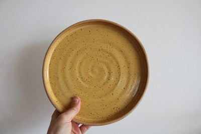 Mustard yellow handmade small ceramic plate with spiral texture